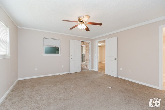 unfurnished bedroom featuring a textured ceiling, ceiling fan, light colored carpet, and crown molding