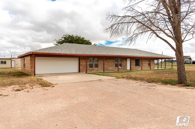 ranch-style house with a garage and a front lawn