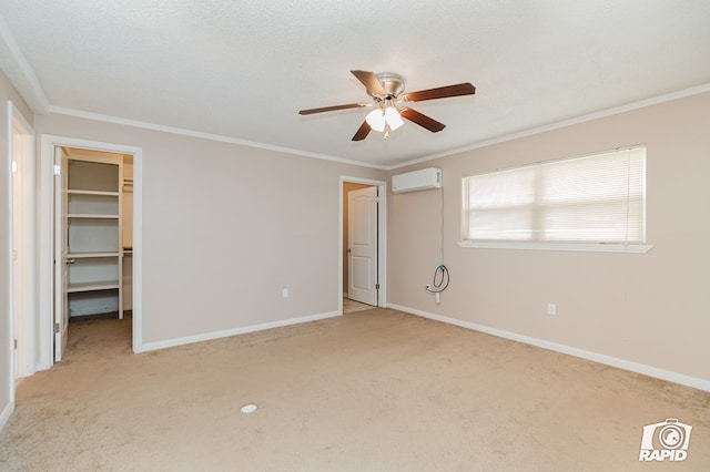 unfurnished bedroom with a walk in closet, light colored carpet, ceiling fan, an AC wall unit, and a closet