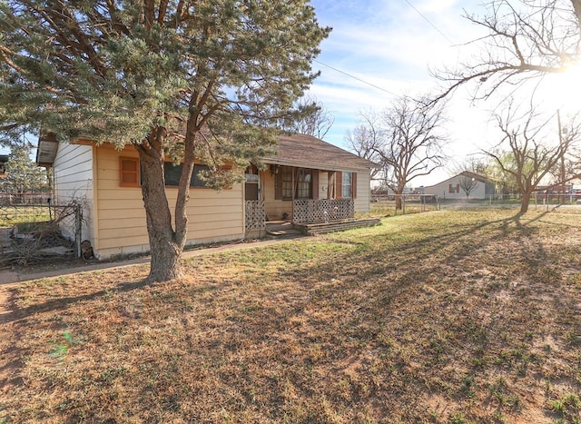 rear view of house with a yard