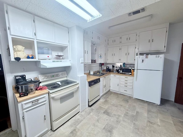 1106 Silas St, Sweetwater, TX 79556 - kitchen with white appliances, extractor fan, a sink, light countertops, and white cabinets