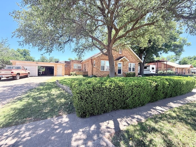 1106 Silas St, Sweetwater, TX 79556 - ranch-style home with driveway, brick siding, and a garage