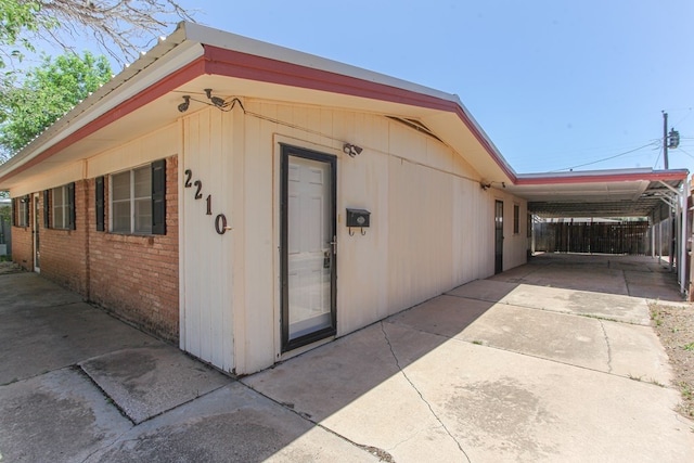 view of side of property with a carport