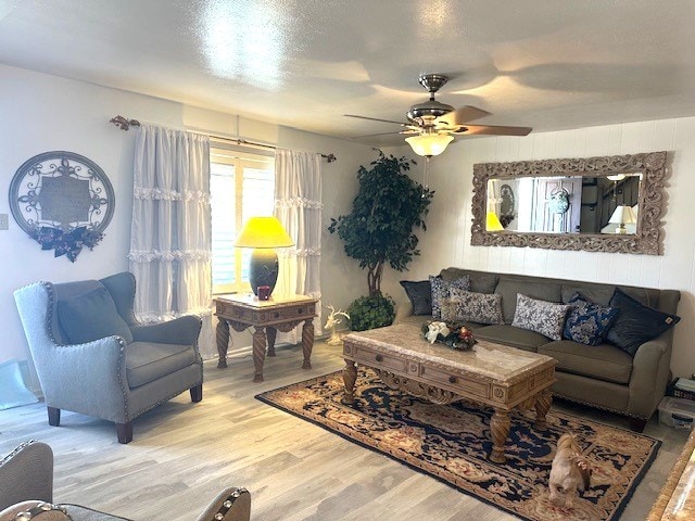 living room featuring ceiling fan and light hardwood / wood-style floors