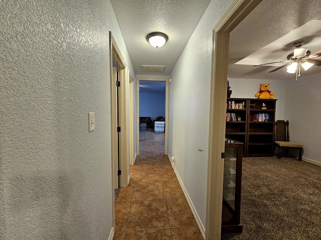 916-B Bronstad Dr, Andrews, TX 79714 - hallway with a textured wall, a textured ceiling, and tile patterned floors