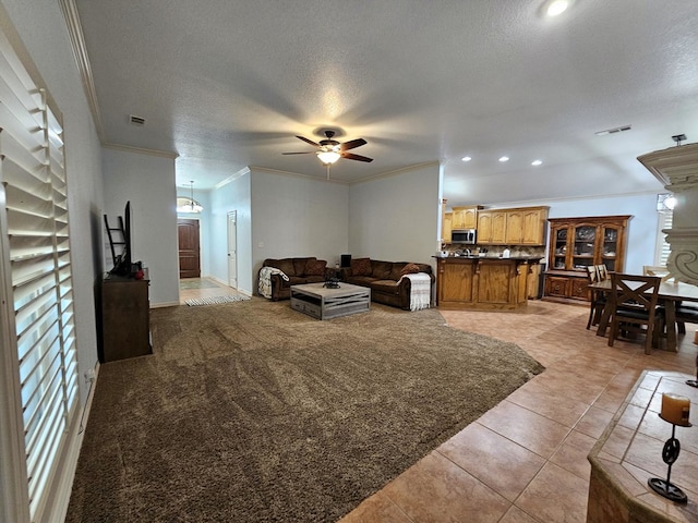 916-B Bronstad Dr, Andrews, TX 79714 - living room featuring crown molding, a ceiling fan, recessed lighting, light tile patterned floors, and a textured ceiling