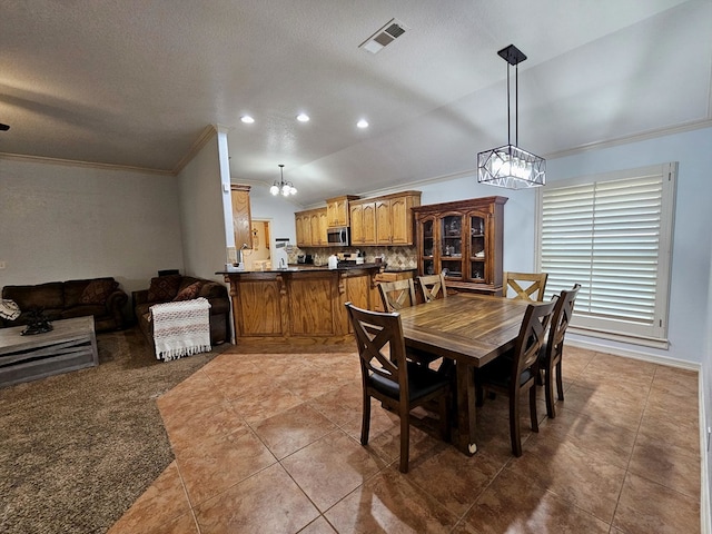 916-B Bronstad Dr, Andrews, TX 79714 - dining space with ornamental molding, tile patterned flooring, vaulted ceiling, a chandelier, and recessed lighting