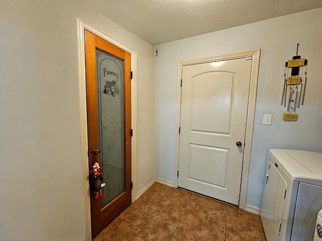 916-B Bronstad Dr, Andrews, TX 79714 - washroom featuring washer and dryer, tile patterned flooring, and a textured ceiling
