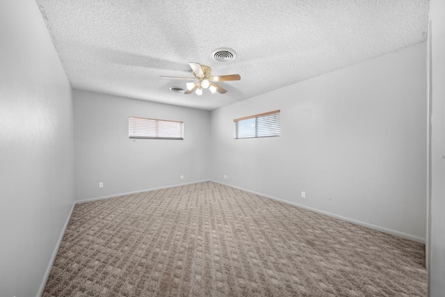 1018 Birdwell Ln, Big Spring, TX 79720 - spare room featuring ceiling fan, carpet floors, and a textured ceiling