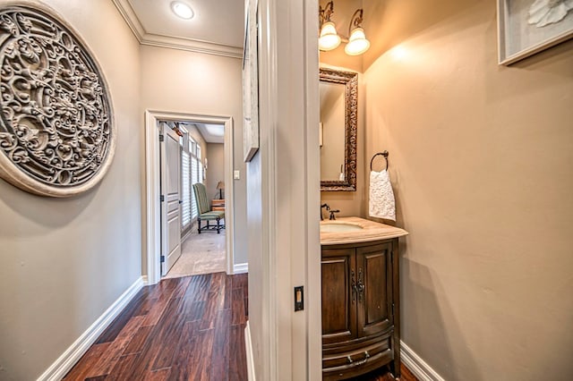 bathroom featuring hardwood / wood-style floors, vanity, and crown molding