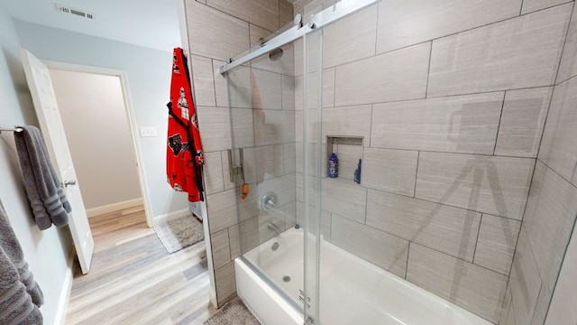 4732 Harvard Ave, Midland, TX 79703 - full bathroom featuring combined bath / shower with glass door, wood finished floors, and baseboards