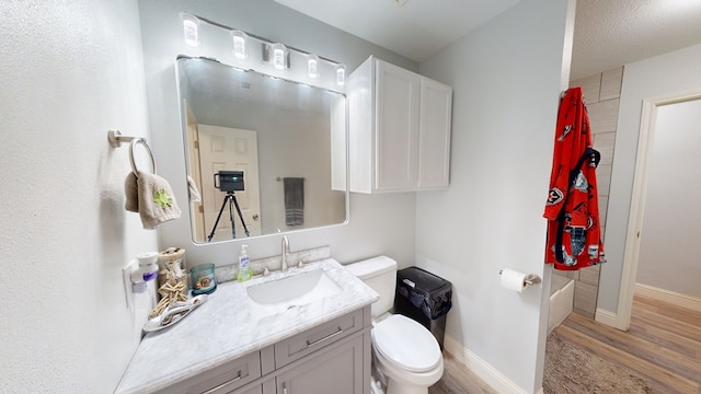 4732 Harvard Ave, Midland, TX 79703 - full bath featuring vanity, wood finished floors, toilet, and baseboards