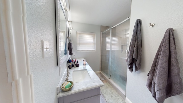4732 Harvard Ave, Midland, TX 79703 - full bath featuring double vanity, a stall shower, and a textured wall