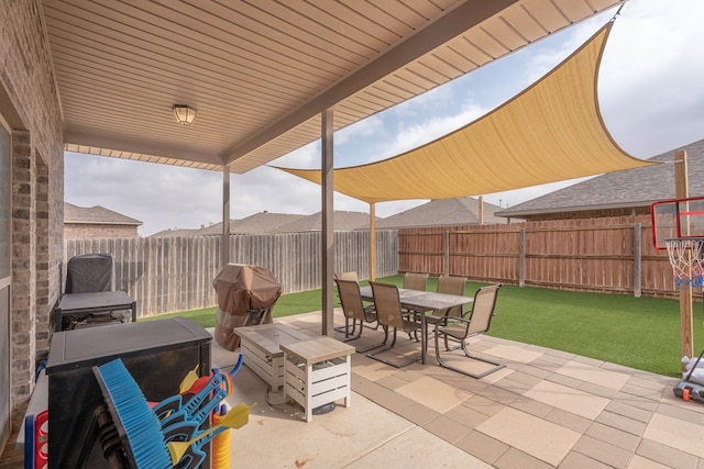 view of patio / terrace with grilling area, a fenced backyard, and outdoor dining area