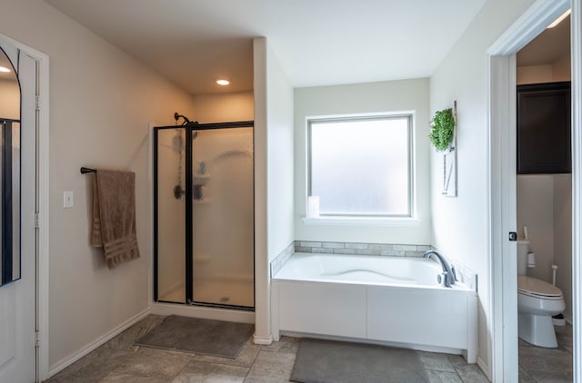 full bath with toilet, a bath, a shower stall, and baseboards
