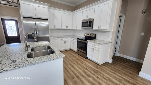 1104 Osprey Dr, Midland, TX 79706 - kitchen with a sink, crown molding, decorative backsplash, baseboards, and appliances with stainless steel finishes