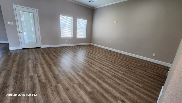 1104 Osprey Dr, Midland, TX 79706 - spare room featuring ornamental molding, baseboards, and dark wood-type flooring