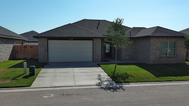 1104 Osprey Dr, Midland, TX 79706 - single story home with concrete driveway, a front yard, an attached garage, and fence