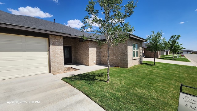 1104 Osprey Dr, Midland, TX 79706 - view of front of home featuring roof with shingles, a front lawn, and brick siding