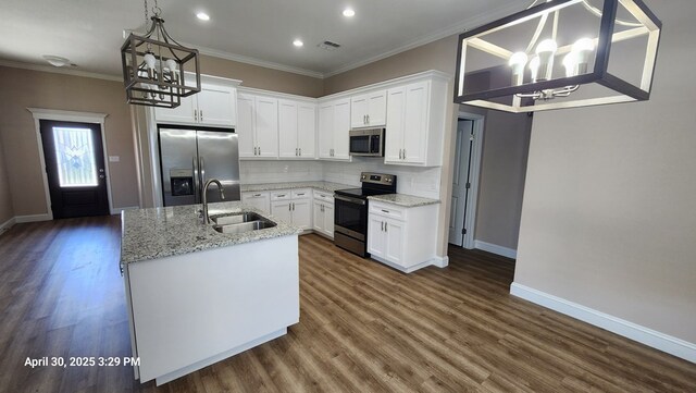 1104 Osprey Dr, Midland, TX 79706 - kitchen with a sink, stainless steel appliances, a kitchen island with sink, baseboards, and a notable chandelier