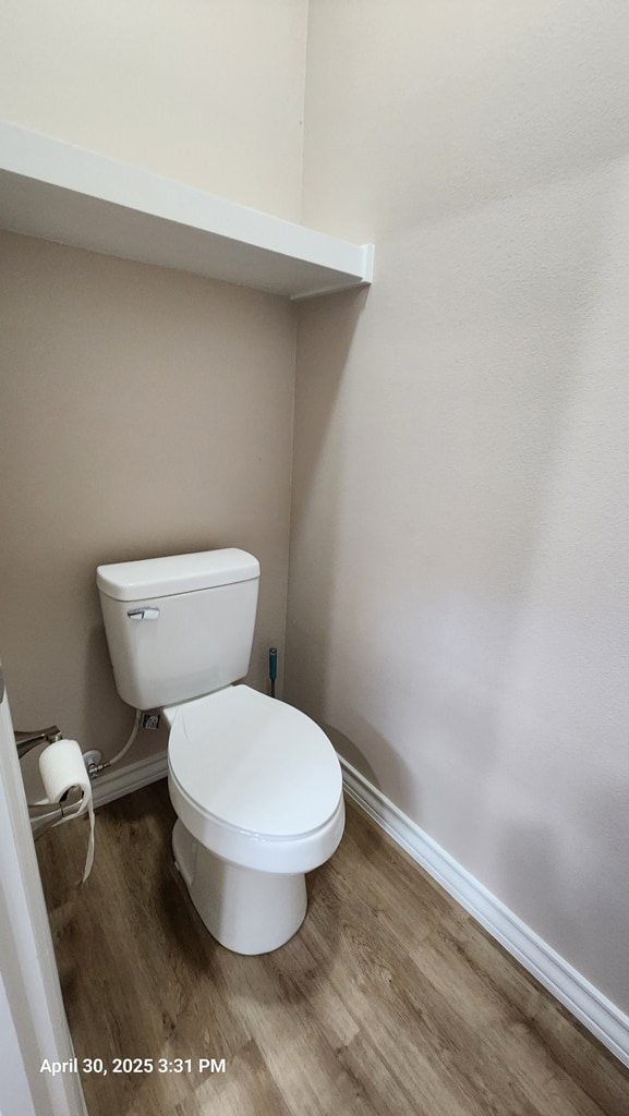 1104 Osprey Dr, Midland, TX 79706 - bathroom with toilet, wood finished floors, and baseboards