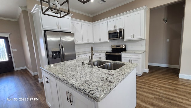 1104 Osprey Dr, Midland, TX 79706 - kitchen featuring crown molding, appliances with stainless steel finishes, baseboards, and a sink