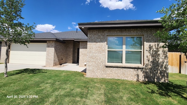 1104 Osprey Dr, Midland, TX 79706 - view of front of home with driveway, brick siding, fence, a garage, and a front yard