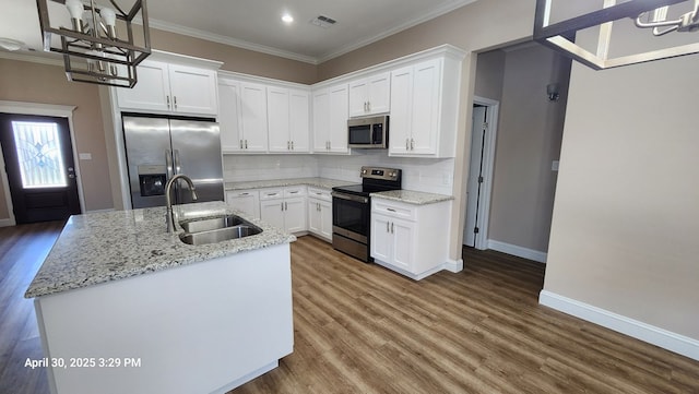 1104 Osprey Dr, Midland, TX 79706 - kitchen with wood finished floors, a sink, stainless steel appliances, baseboards, and a chandelier