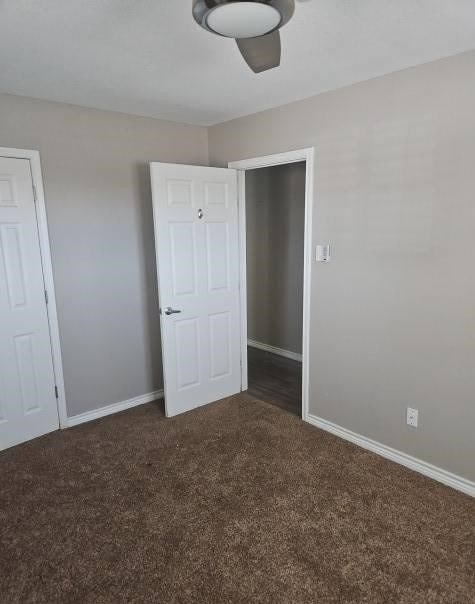 1204 Boykin Rd, Big Spring, TX 79720 - unfurnished bedroom with dark carpet and baseboards