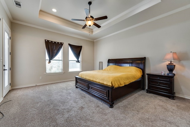 carpeted bedroom with a raised ceiling, ceiling fan, and ornamental molding