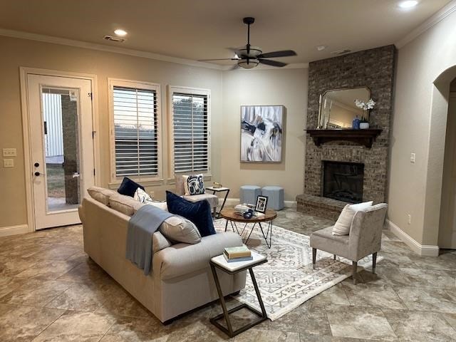 living room featuring a fireplace, ceiling fan, and ornamental molding