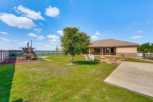 view of yard with a playground and a patio