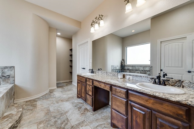 bathroom with vanity and a tub