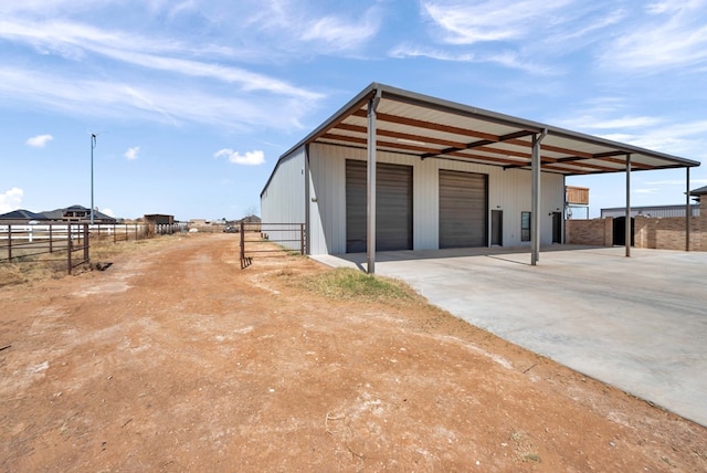 view of pole building with fence