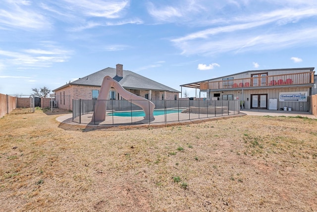 view of swimming pool with a fenced in pool and fence