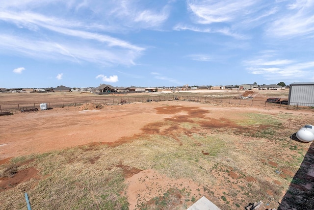 view of yard with a rural view and fence