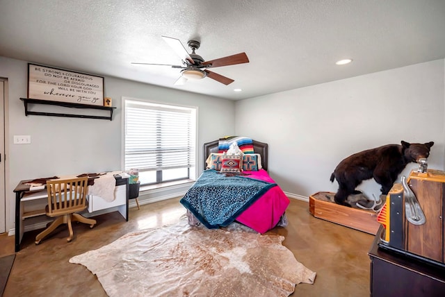 bedroom featuring recessed lighting, finished concrete flooring, baseboards, and a textured ceiling