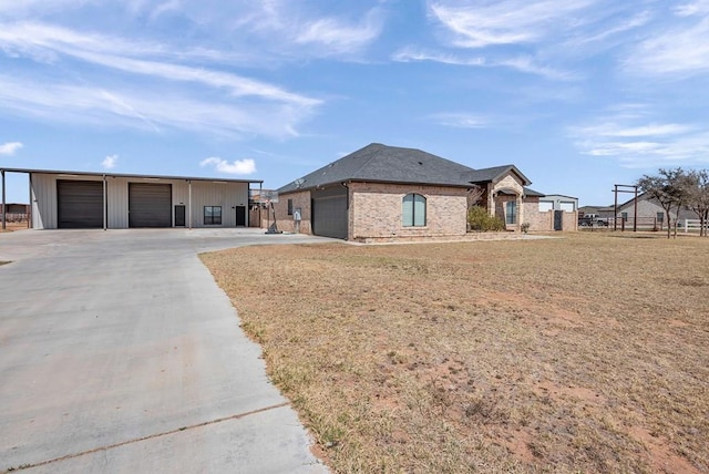 view of front of home with a garage, brick siding, and fence