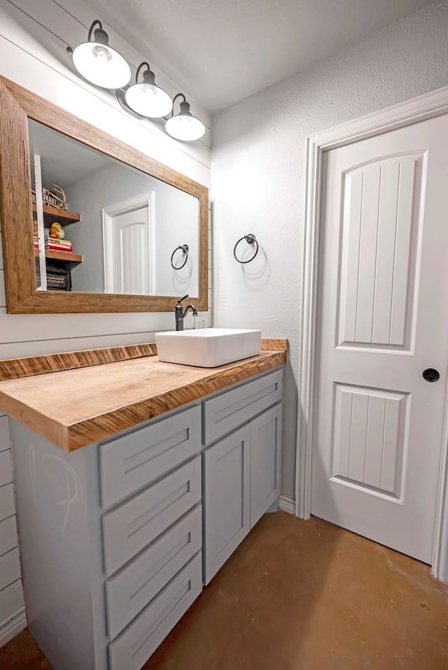 bathroom with vanity and concrete floors