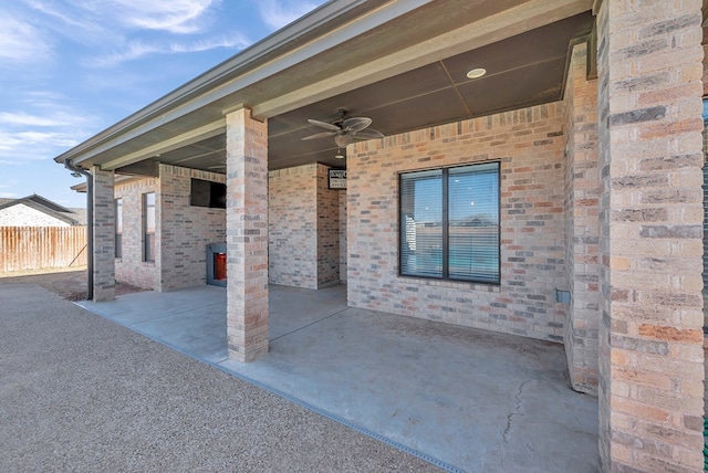 view of patio featuring ceiling fan and fence