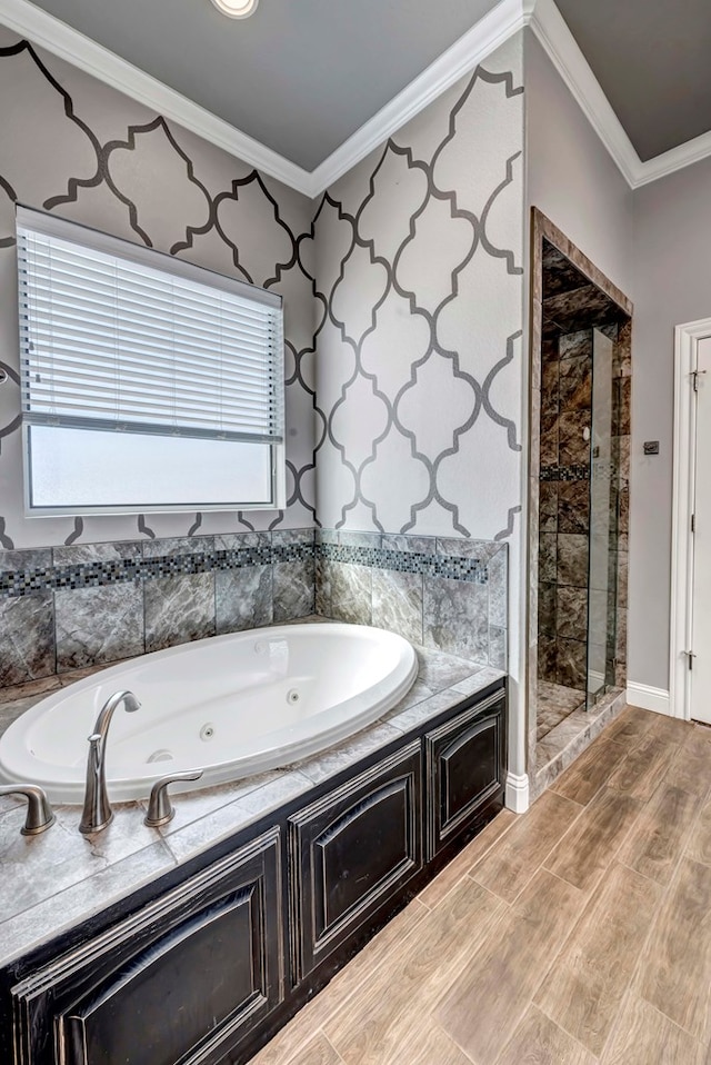 full bathroom with a tub with jets, a stall shower, crown molding, and wood finish floors