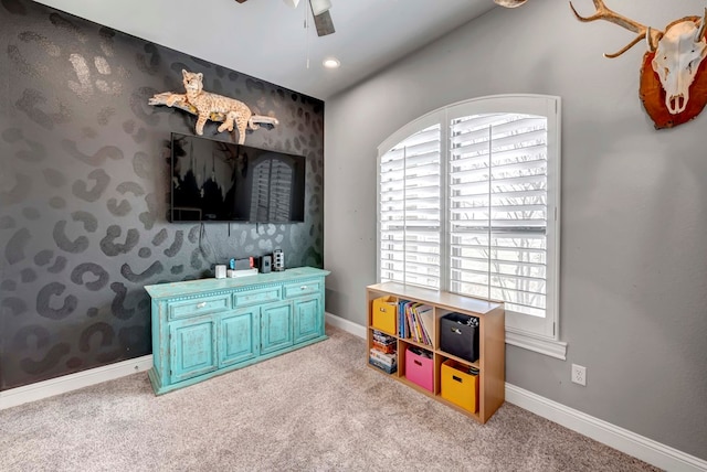 game room featuring wallpapered walls, light colored carpet, baseboards, and ceiling fan