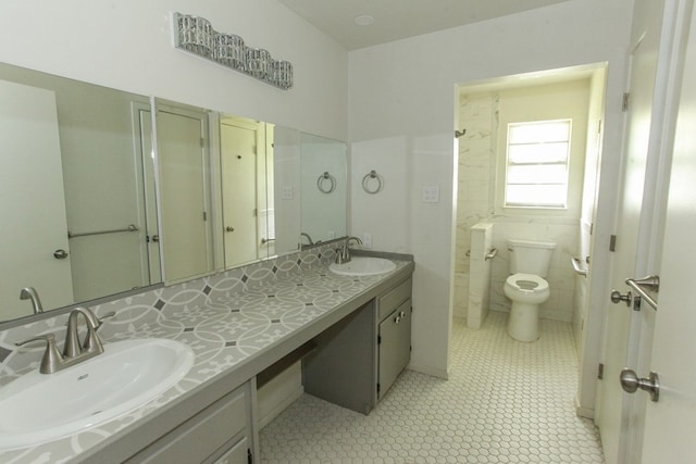 bathroom featuring tile patterned flooring, vanity, and toilet