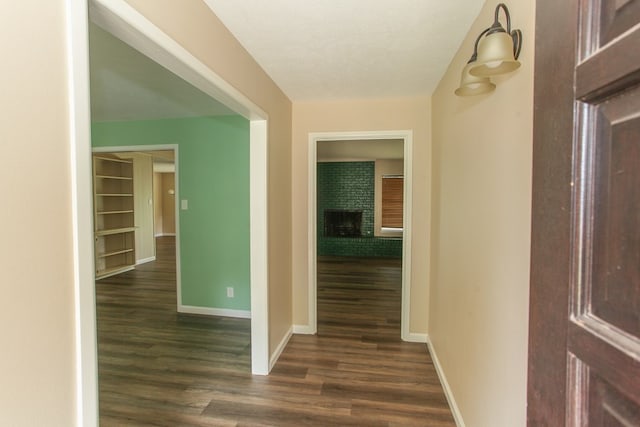 hallway featuring a textured ceiling and dark hardwood / wood-style floors