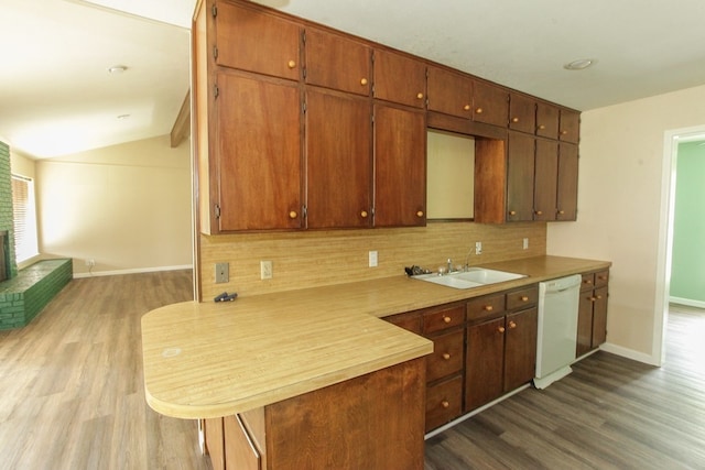 kitchen with decorative backsplash, kitchen peninsula, dark hardwood / wood-style flooring, vaulted ceiling, and dishwasher