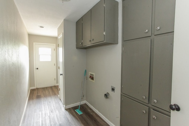 clothes washing area with electric dryer hookup, hookup for a washing machine, dark hardwood / wood-style flooring, and cabinets