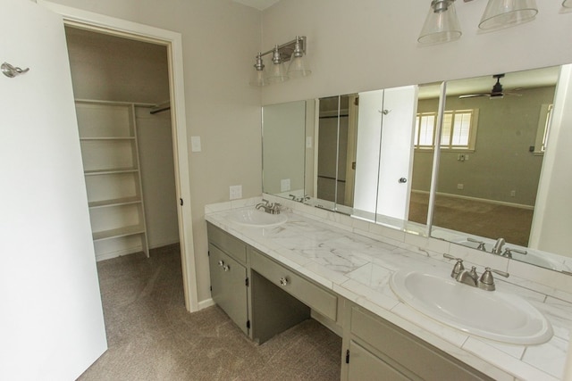 bathroom with ceiling fan and vanity