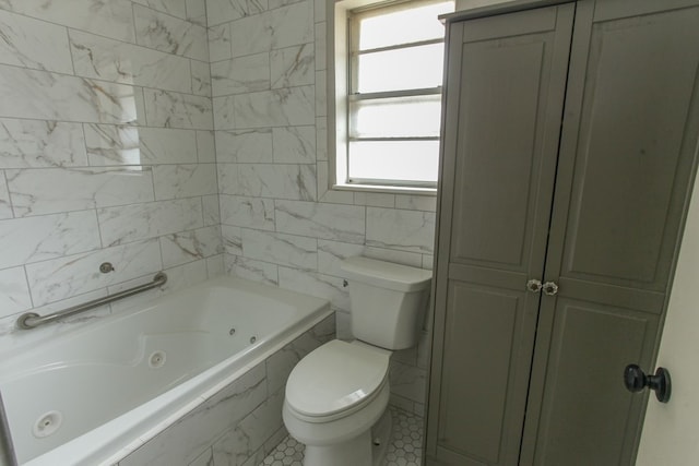 bathroom featuring tiled bath, tile walls, and toilet