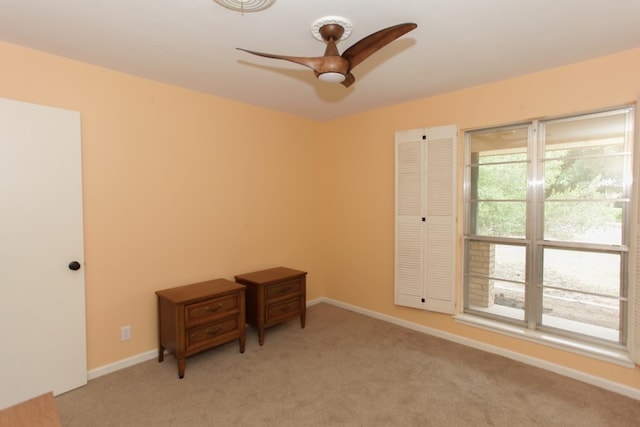 carpeted empty room with ceiling fan