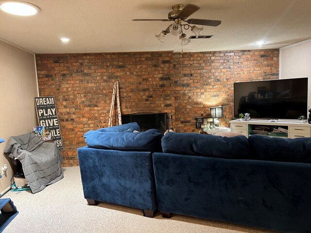 living room with a textured ceiling, light colored carpet, ceiling fan, and brick wall